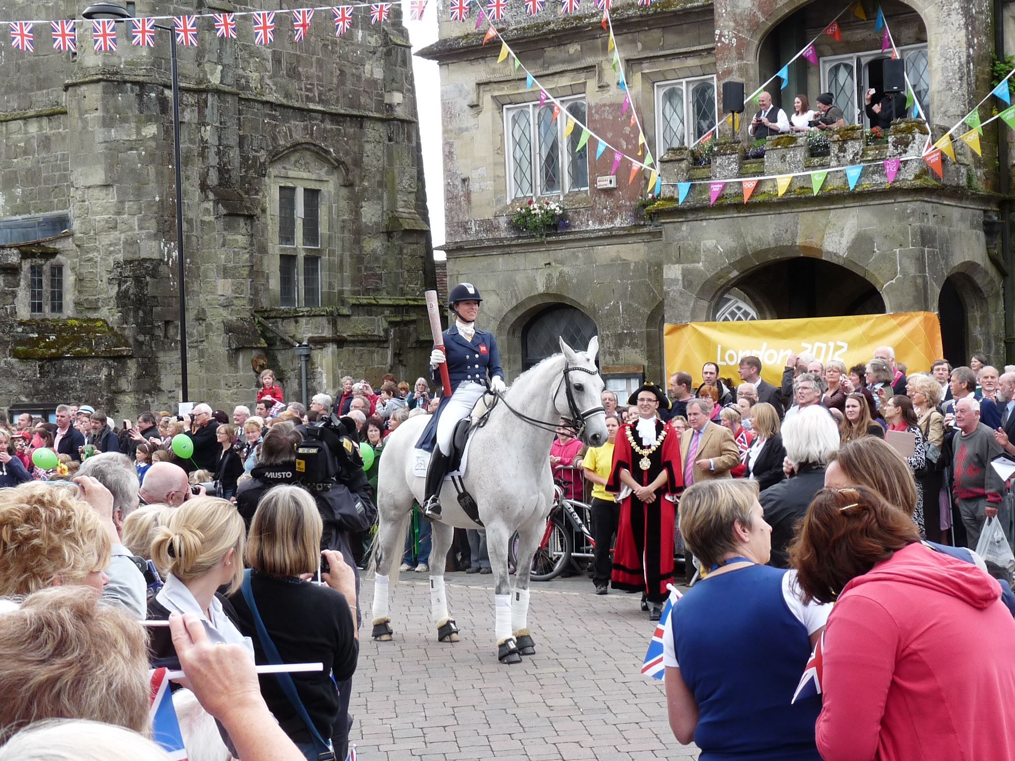 Hannah Biggs riding Southern Cross Stud's Ice Age carrying the 2012 Olympic torch.
